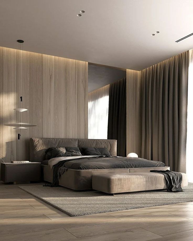 غرفة نوم عصرية بتصميم بسيط، تحتوي على سرير مزدوج مع لحاف مريح وألوان هادئة.